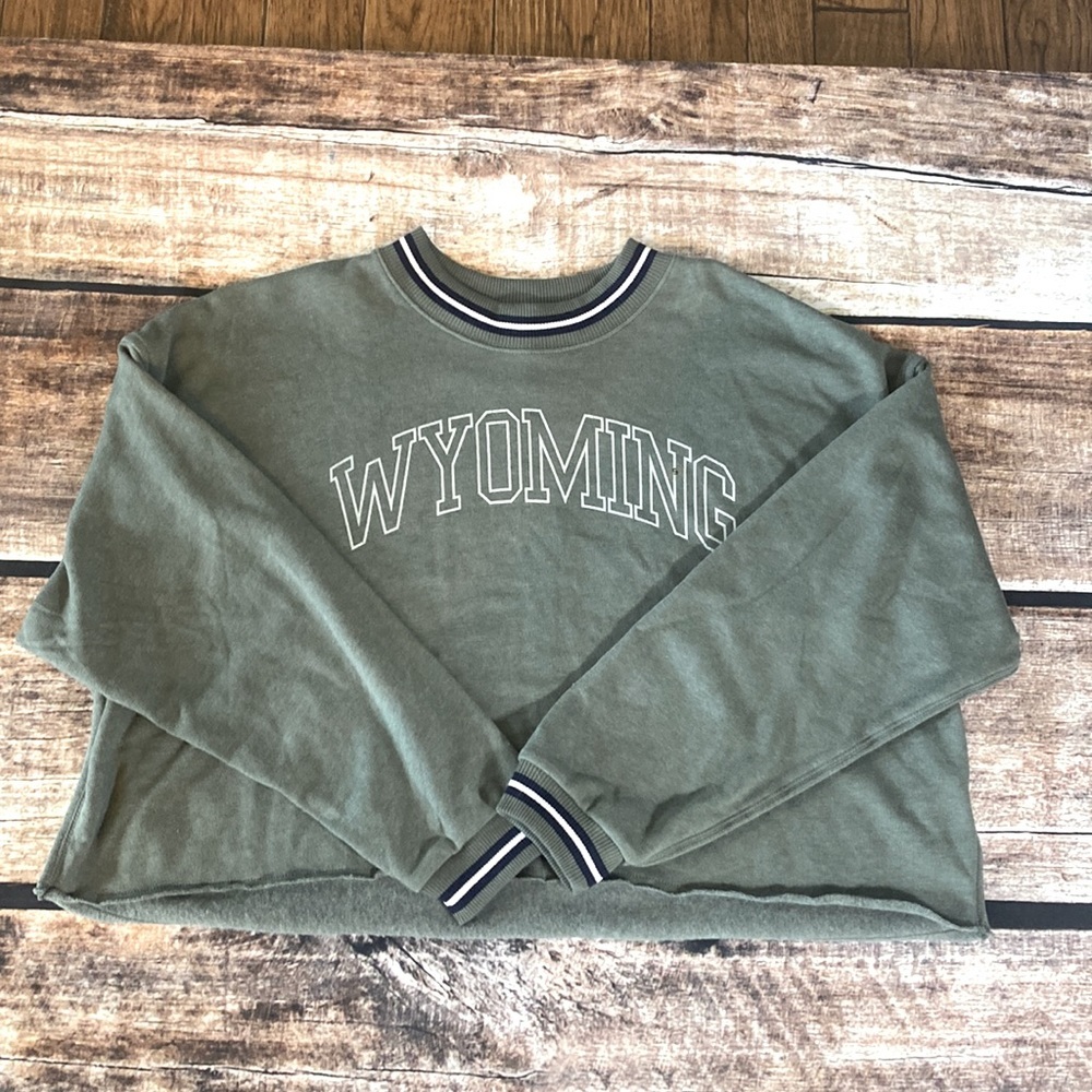 AE army green small cropped sweatshirt Wyoming logo across chest.